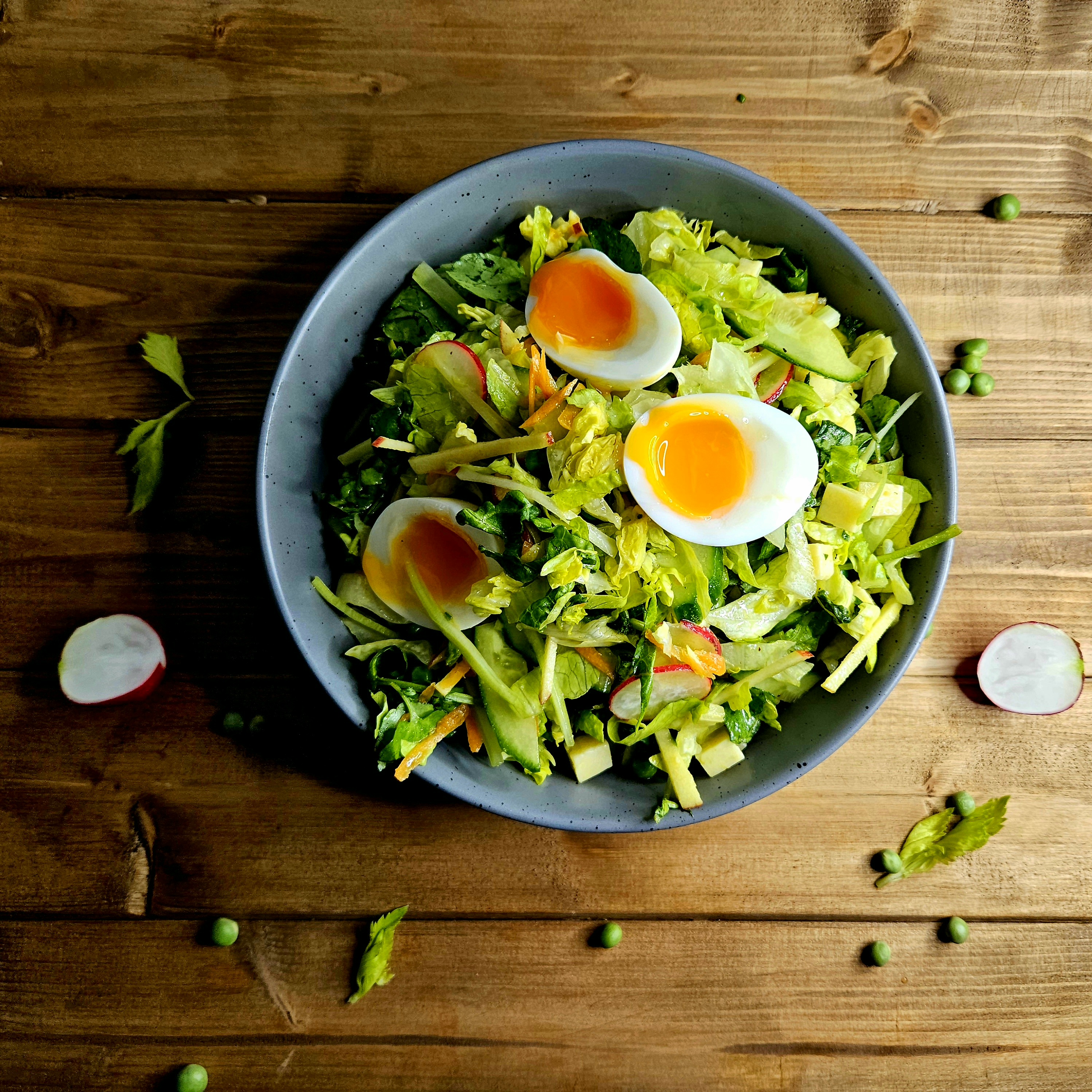 English Garden Salad with English Mustard VInaigrette topped with eggs Fresh english vegetables including apples, carrots, watercress, lettuce, fresh peas, eggs, and cheddar cheese