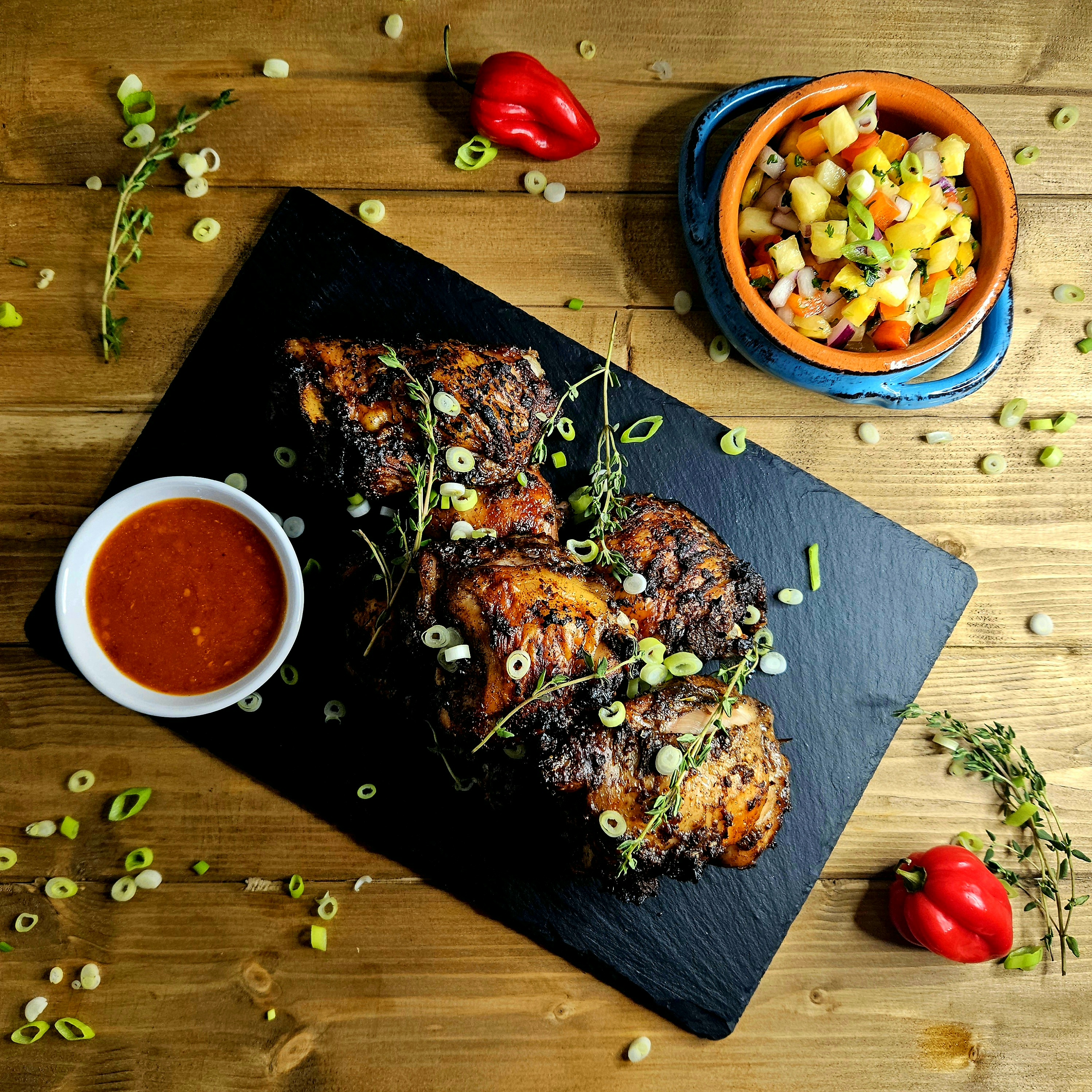 Carribean Jerk Chicken with Hot Sauce and Pineaple Salsa. Marinade includes scotch bonnet chillies and allspice.