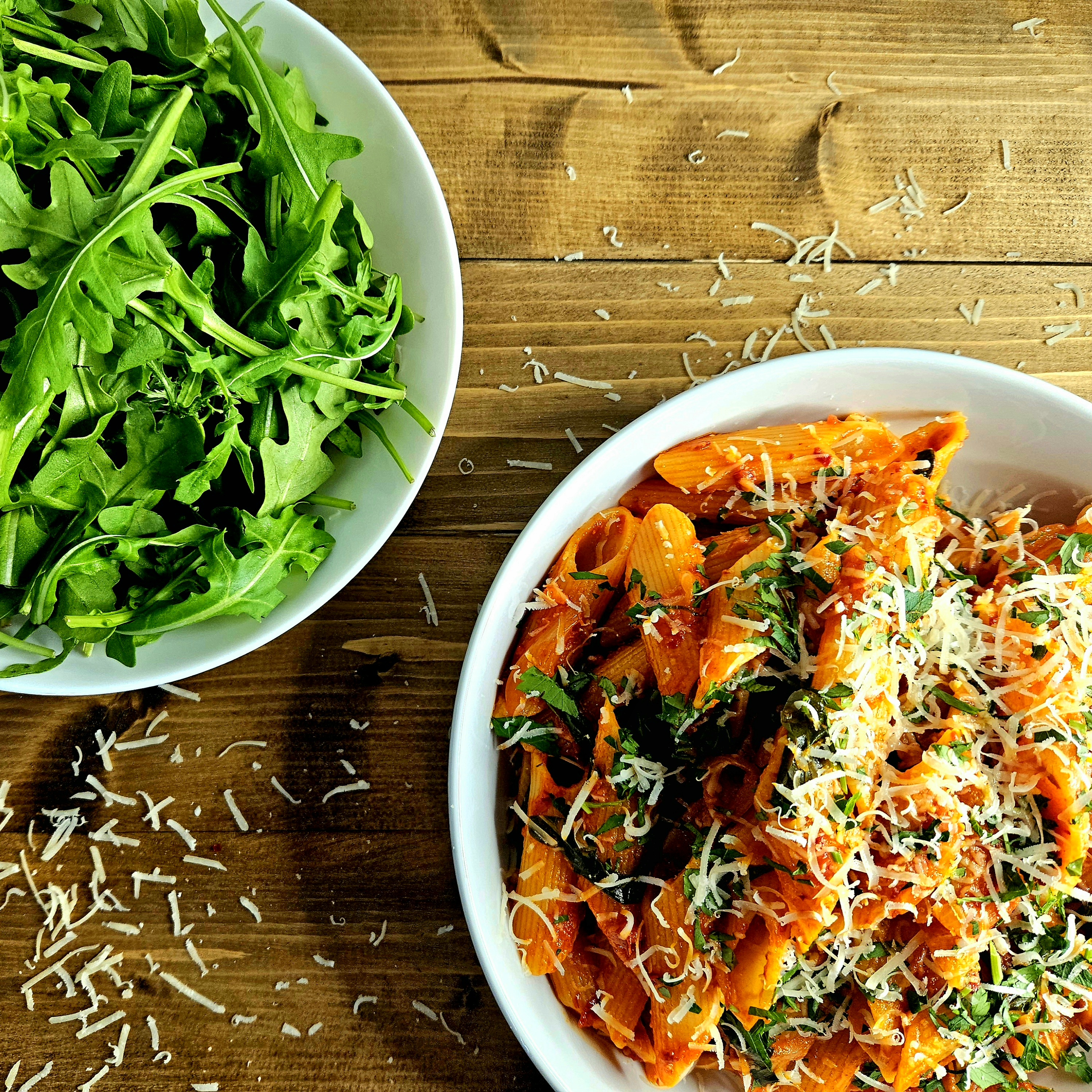 Pasta with 'Nduja or Pasta con 'Nduja with a bowl of rocket (arugula)