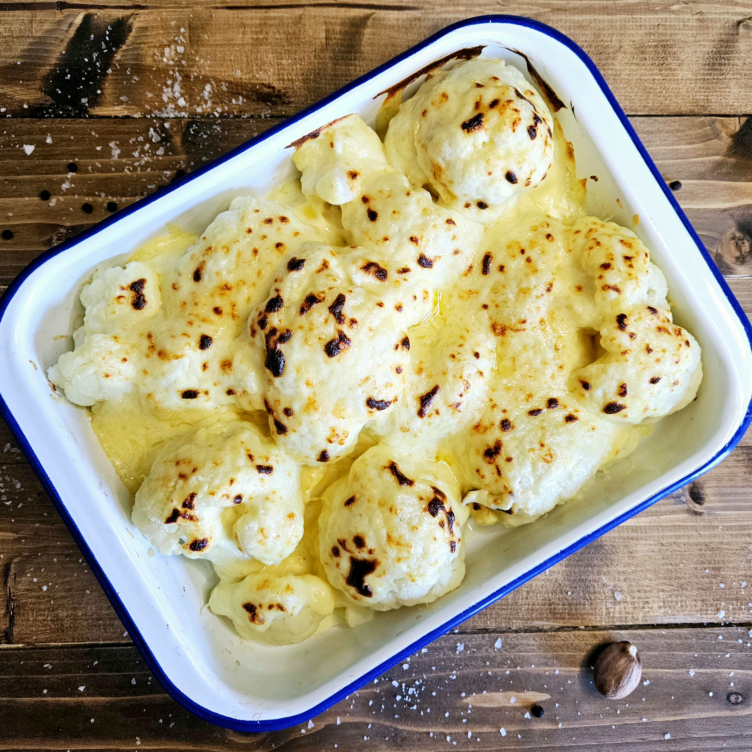 Caulfilower Cheese grileld beneath an overhead grill