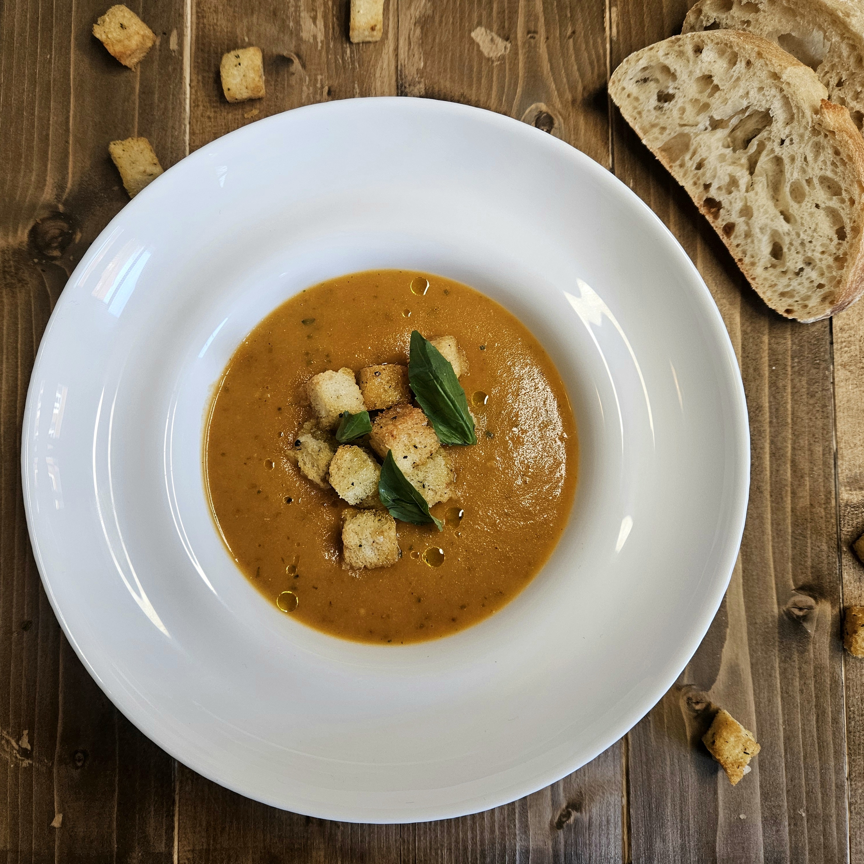 Classic Basil & Tomato Soup with Croutons and Basil Leaves