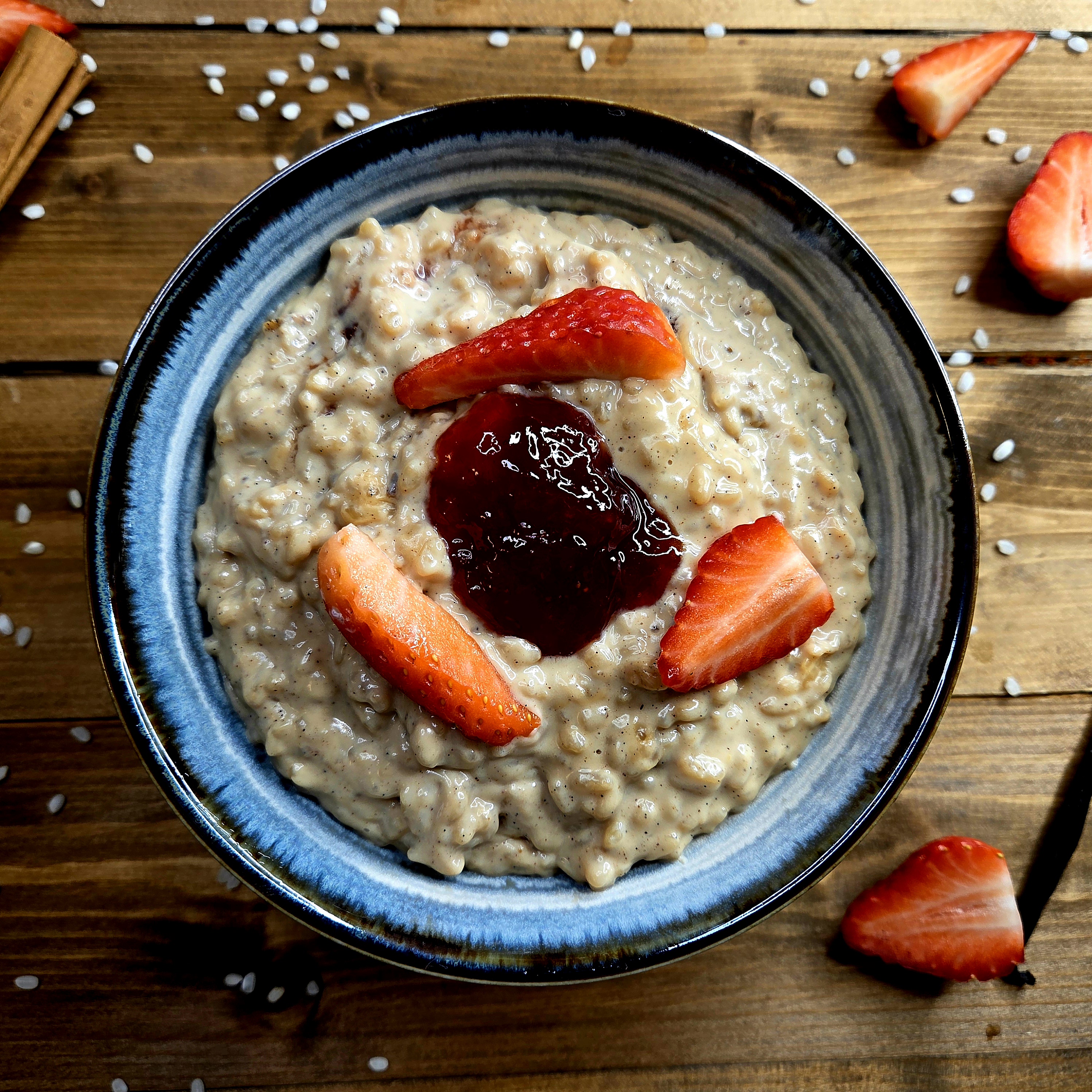 Rice pudding topped with jam and strawberries